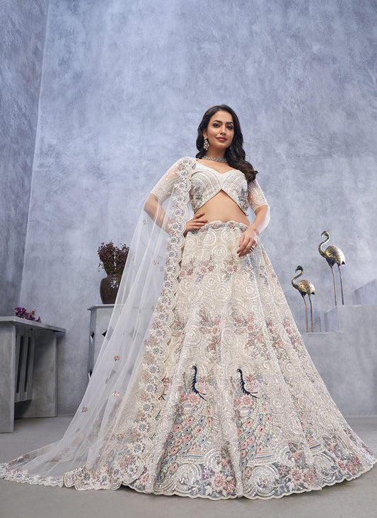 Charming Ivory Net Lehenga With Zari Embroidered And Stone Sequins Work Wedding Wear