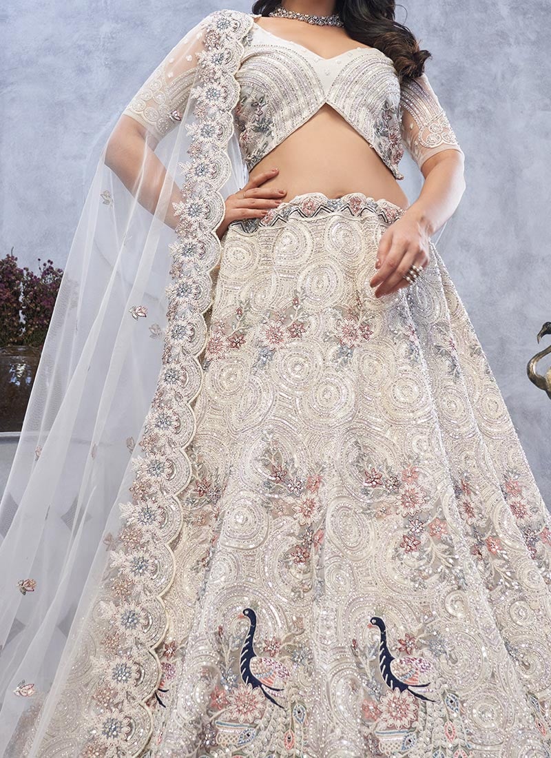 Charming Ivory Net Lehenga With Zari Embroidered And Stone Sequins Work Wedding Wear