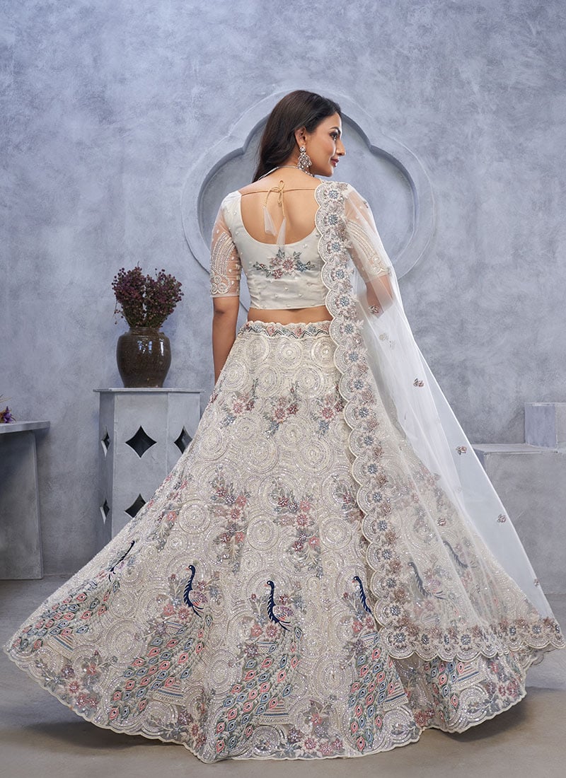 Charming Ivory Net Lehenga With Zari Embroidered And Stone Sequins Work Wedding Wear